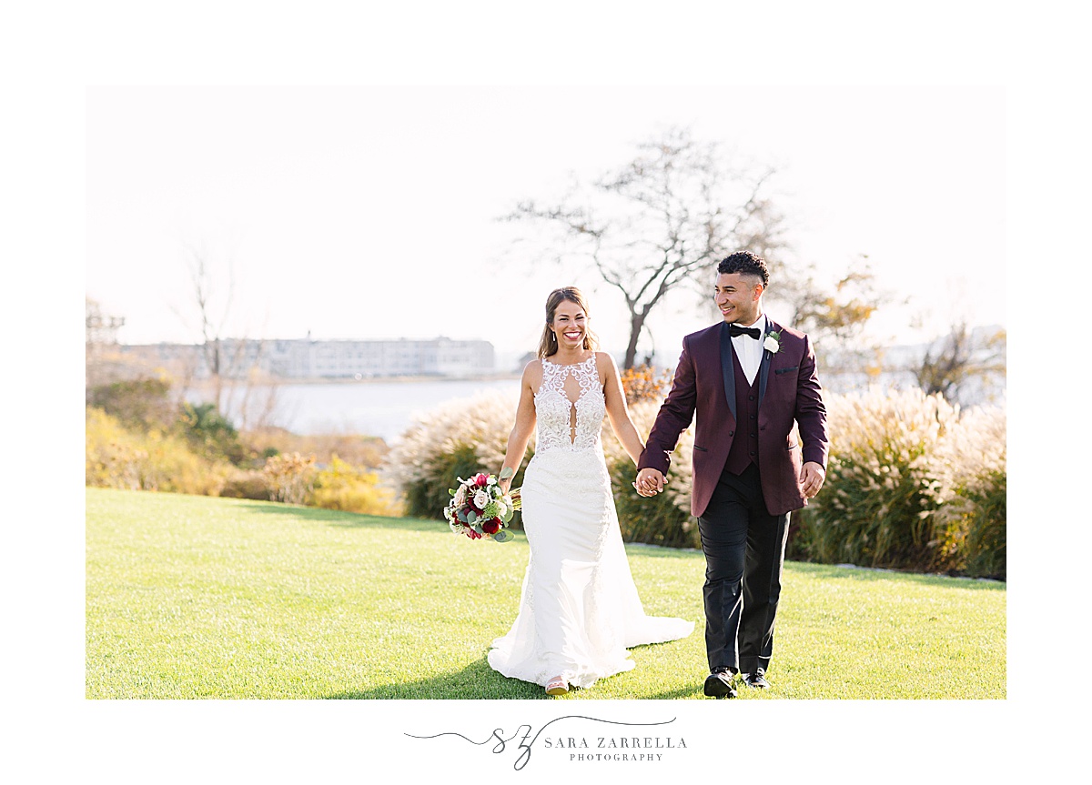 bride and groom walk during wedding photos in Middletown RI