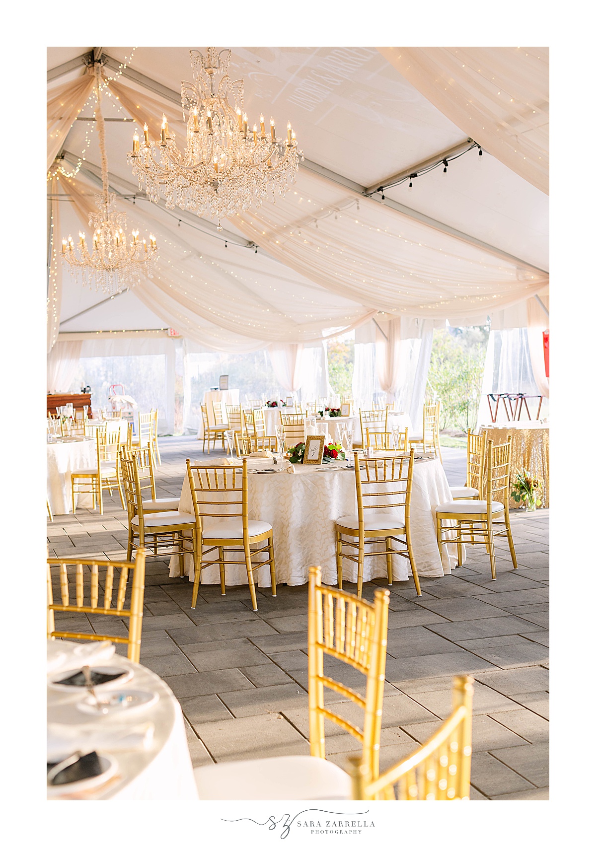 wedding reception inside tent with gold chivari chairs at Atlantic Resort Newport Wedding