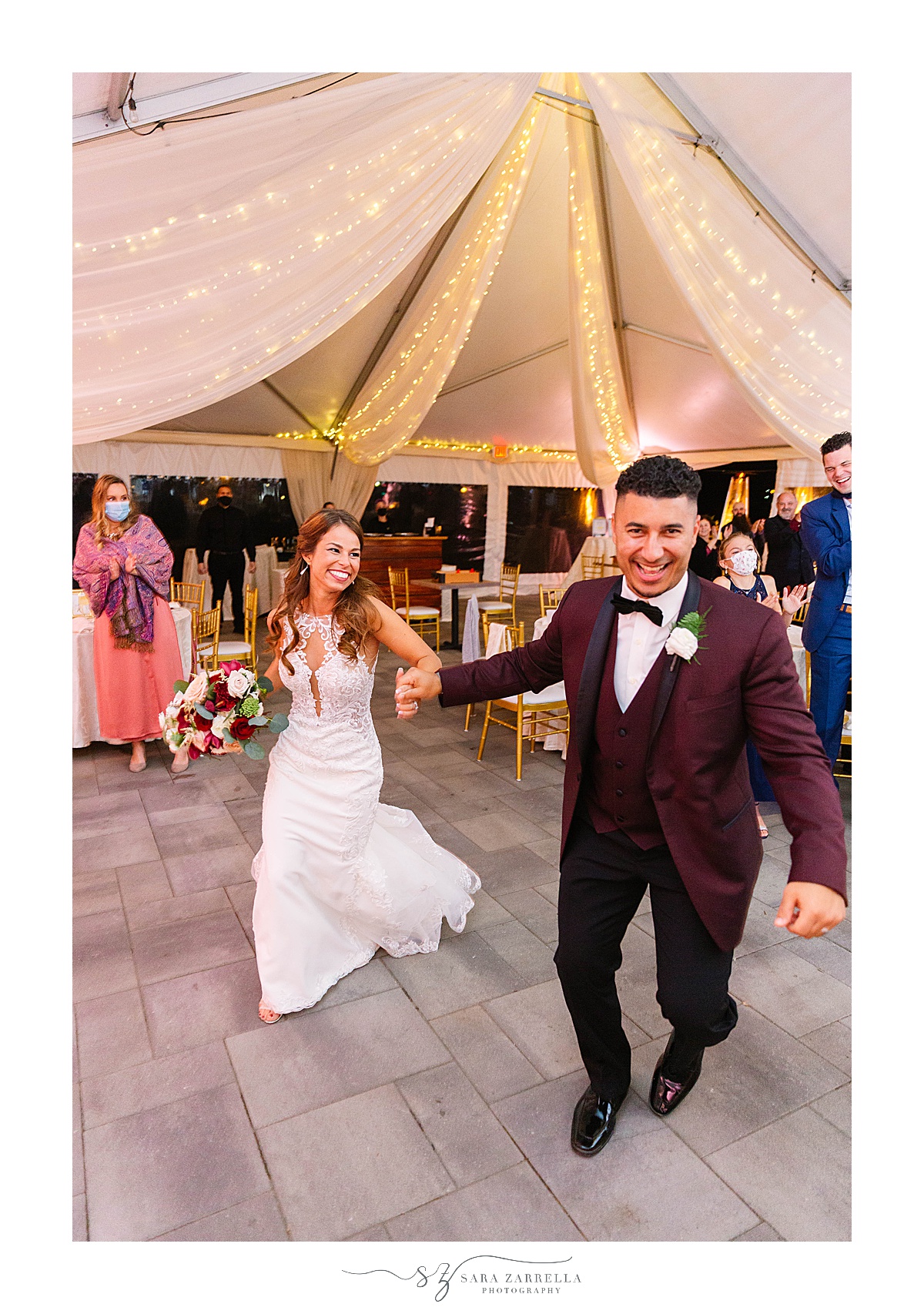 bride and groom run into wedding reception