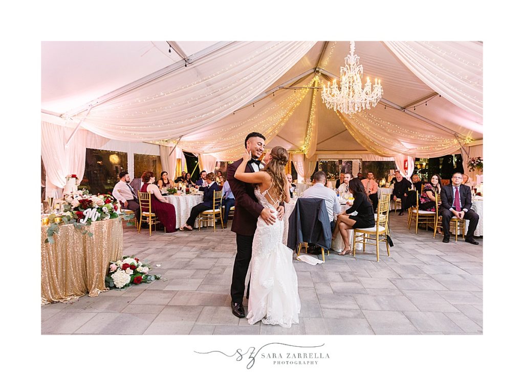 bride and groom have first dance under tent at Atlantic Resort Newport