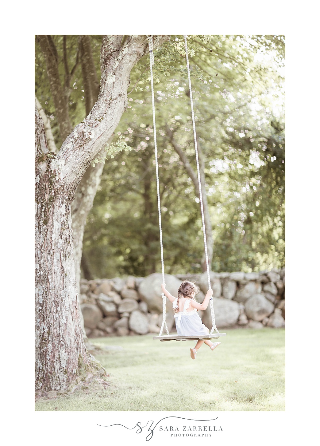 girl swings on wooden swing at Gerald's Farm