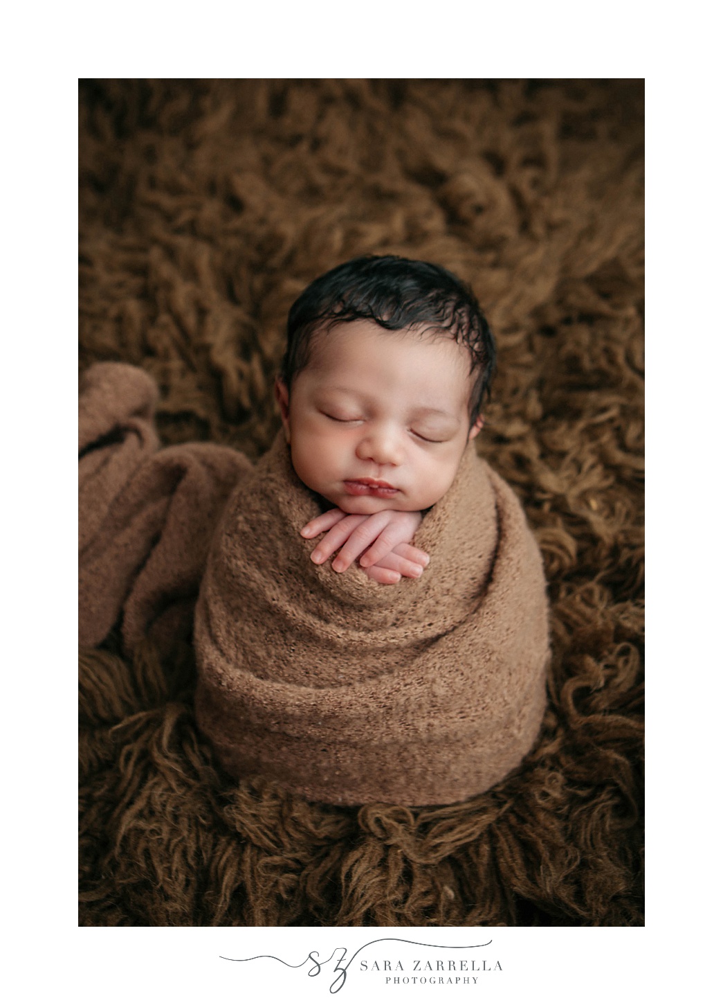baby in brown wrap sleeps during Rhode Island newborn portraits 