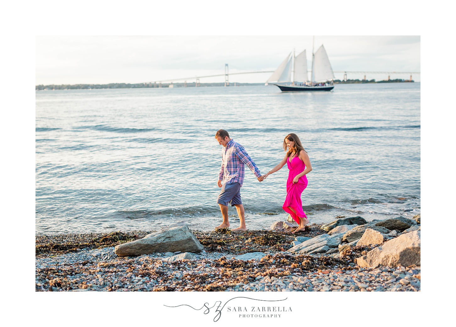 couple walks along beach during summer engagement photos