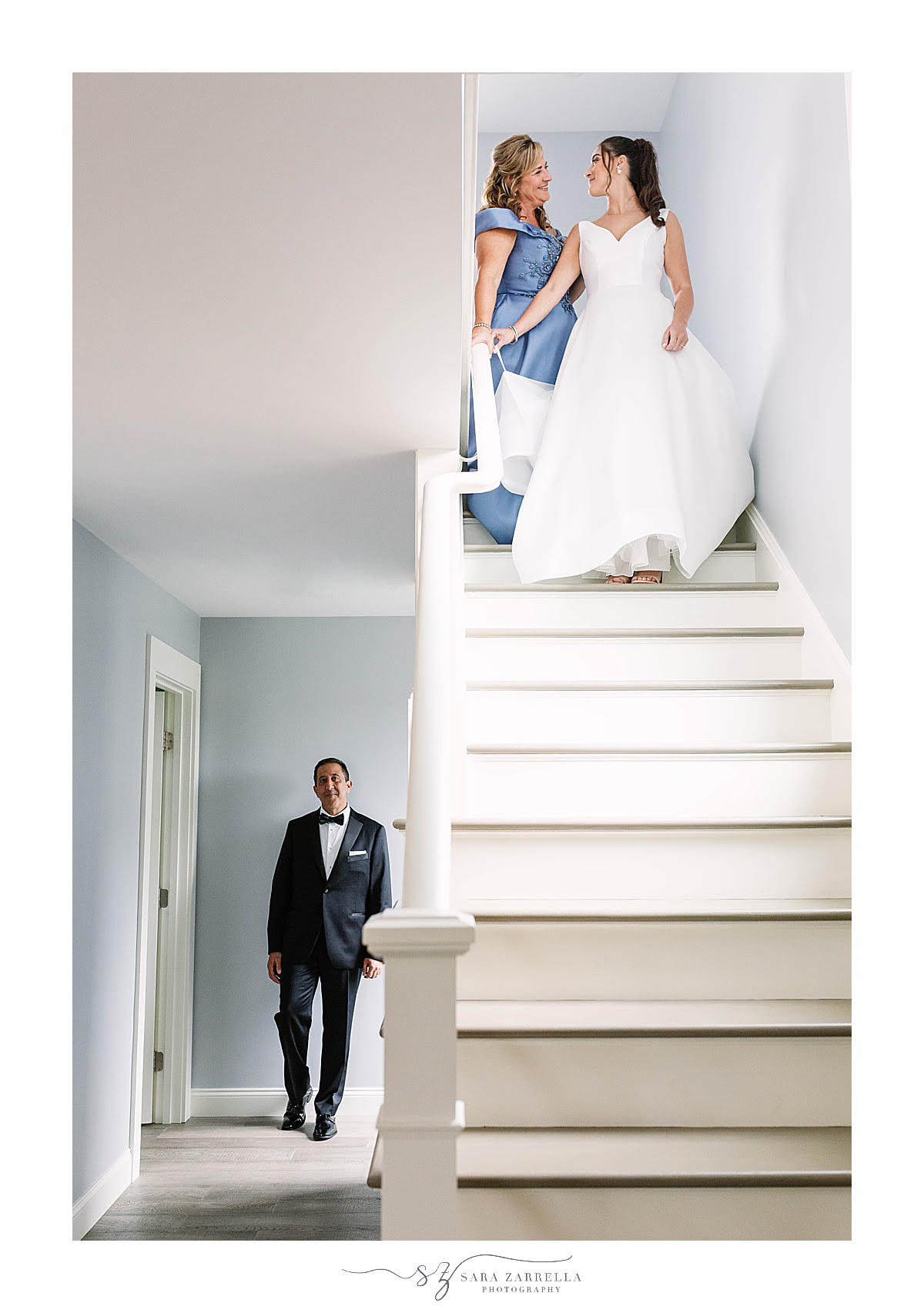 bride walks down steps to see dad for first look