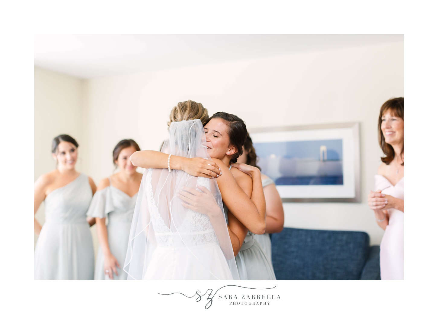 bride and bridesmaid hug during bridesmaid reveal at RI wedding