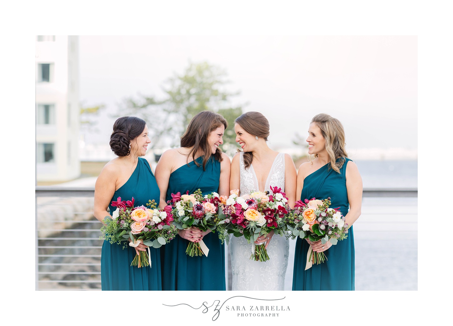 bride laughs with bridesmaids during Rhode Island wedding day