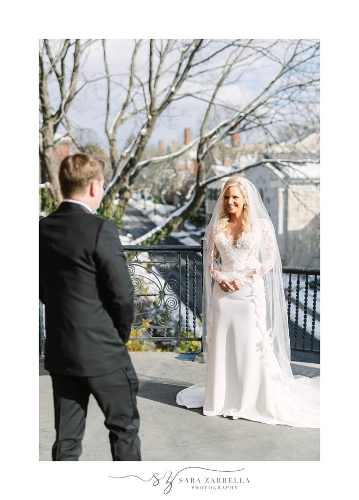 groom walks to bride during first look on balcony at Hope Club