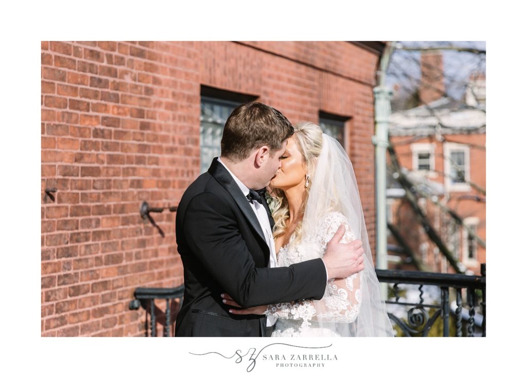 groom kisses bride during first look in Rhode Island