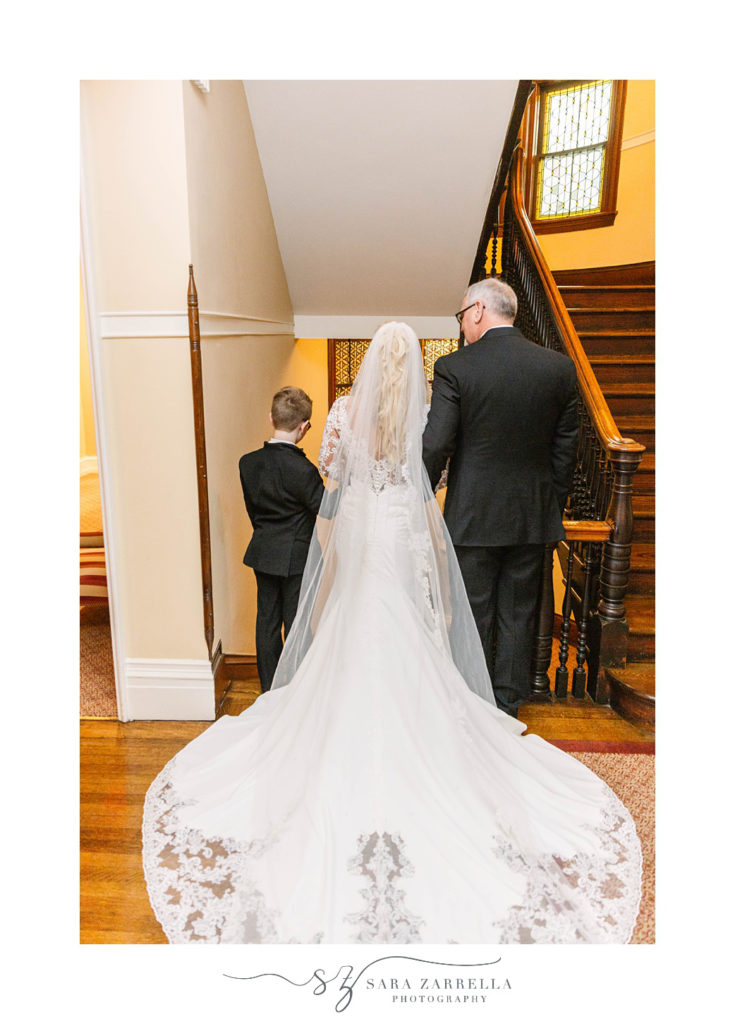 bride enters wedding ceremony with father and son at Hope Club