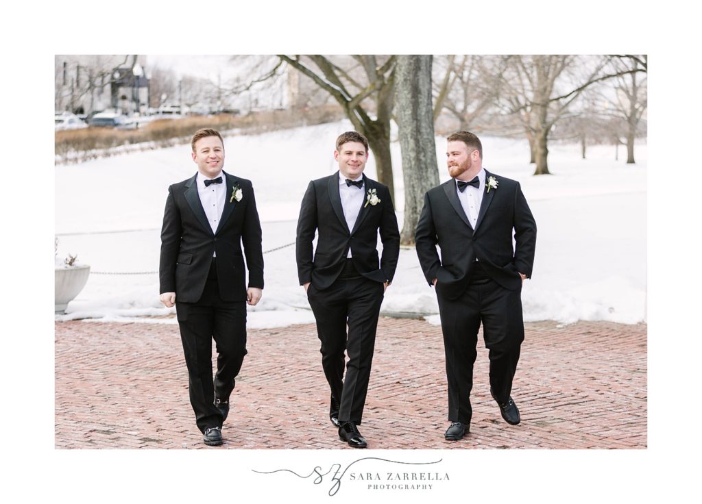 groom walks with two groomsmen in Providence RI