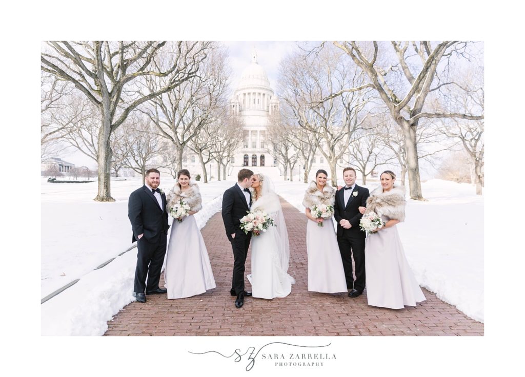 bridal party poses in the snow during Providence RI wedding photos