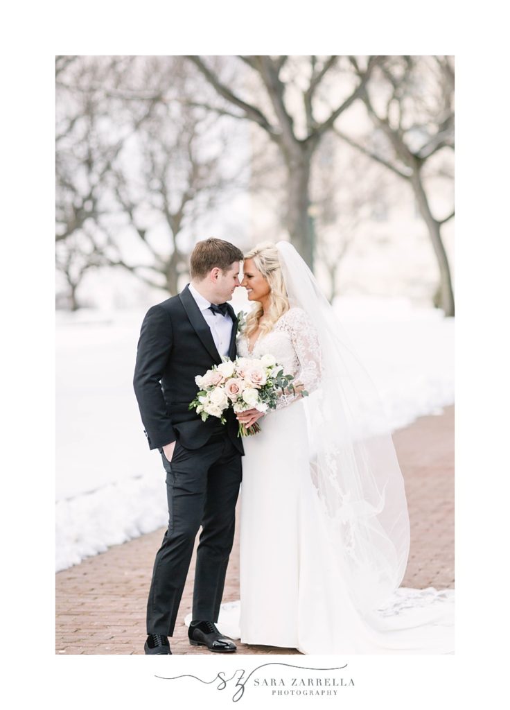 romantic winter wedding portraits of bride and groom in the snow