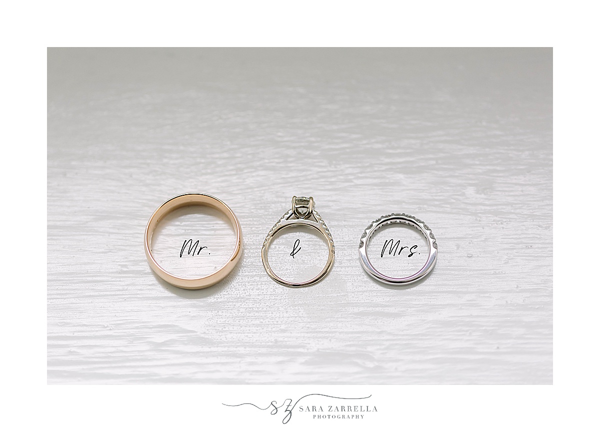 wedding bands rest on white paper