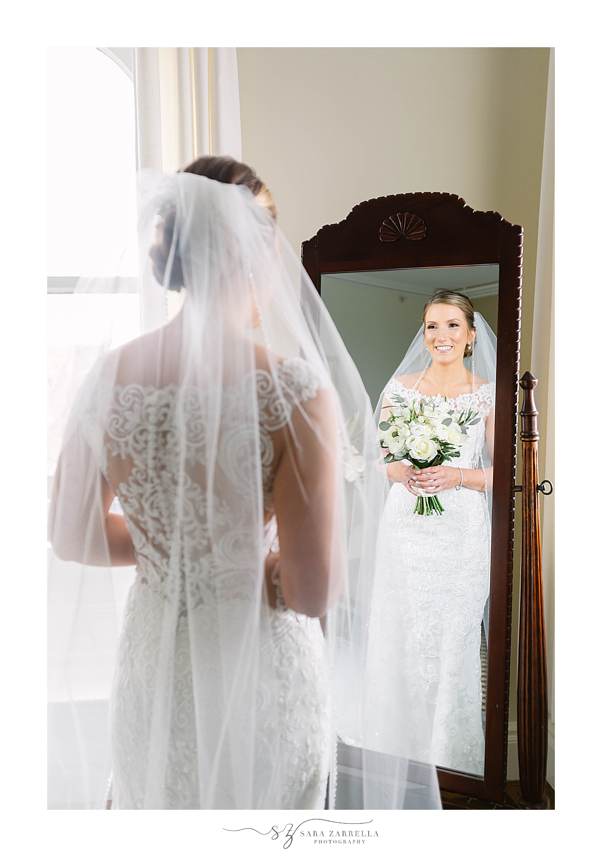bride looks at herself in mirror before RI wedding