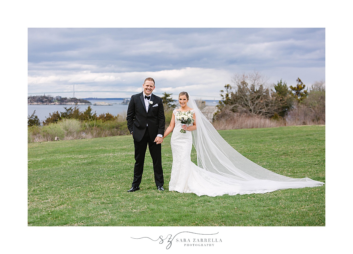 bride and groom pose on lawn at OceanCliff Hotel