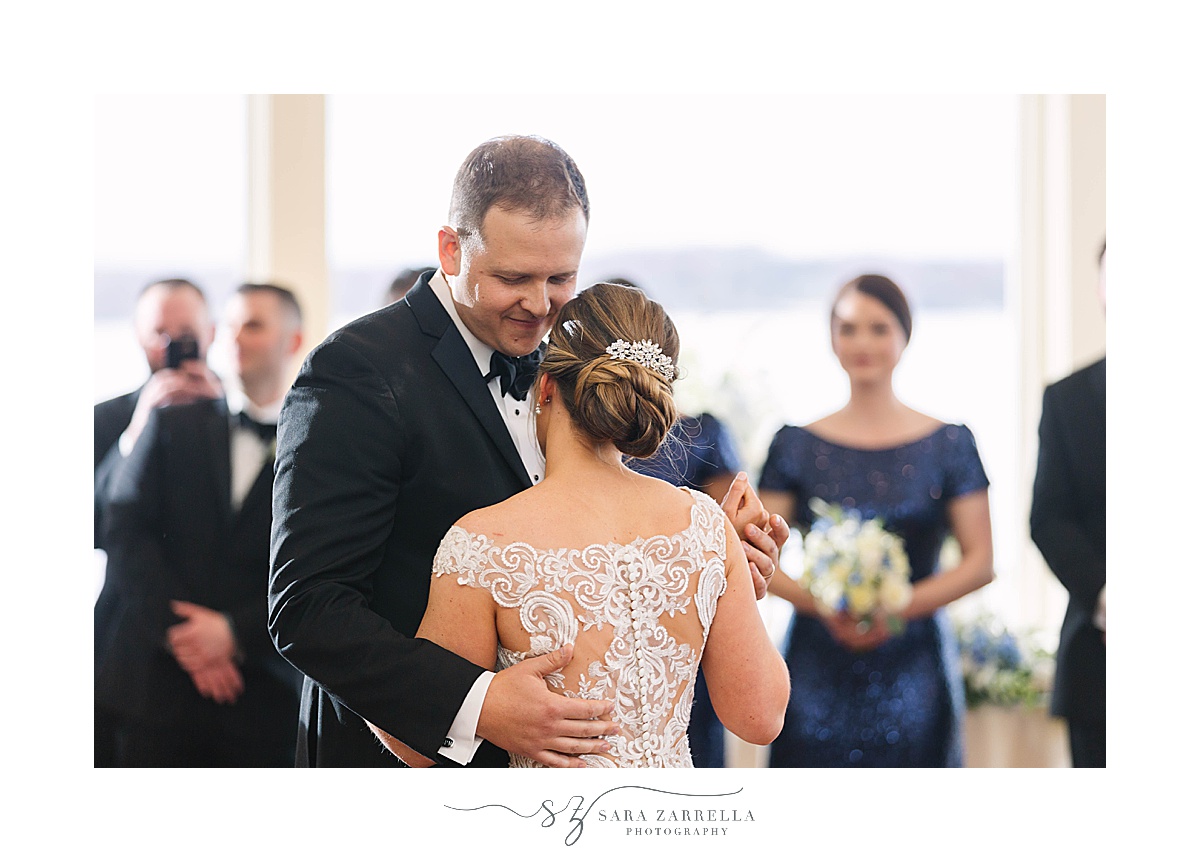 groom looks down at bride during first dance