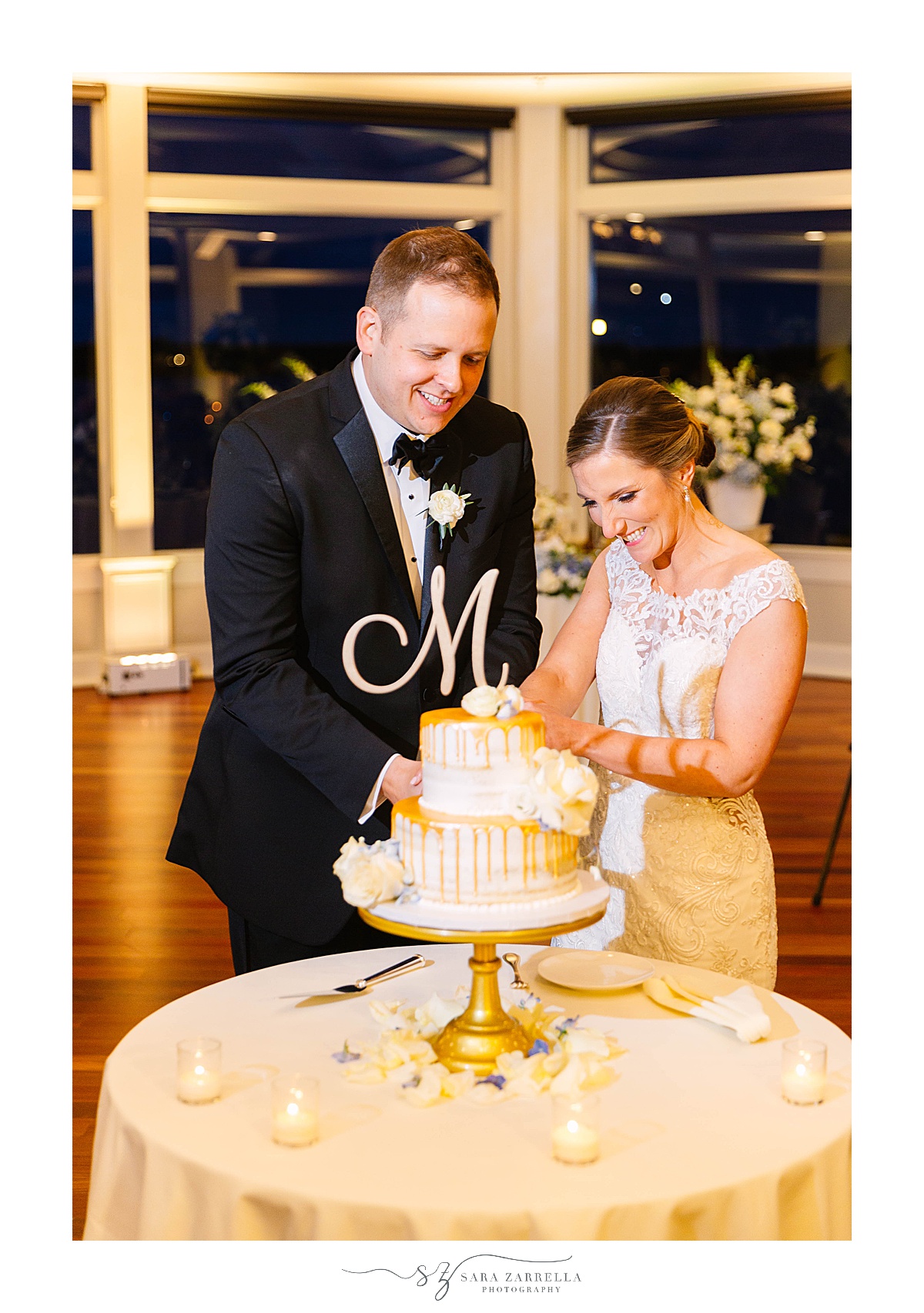 newlyweds cut wedding cake at OceanCliff Hotel Wedding reception
