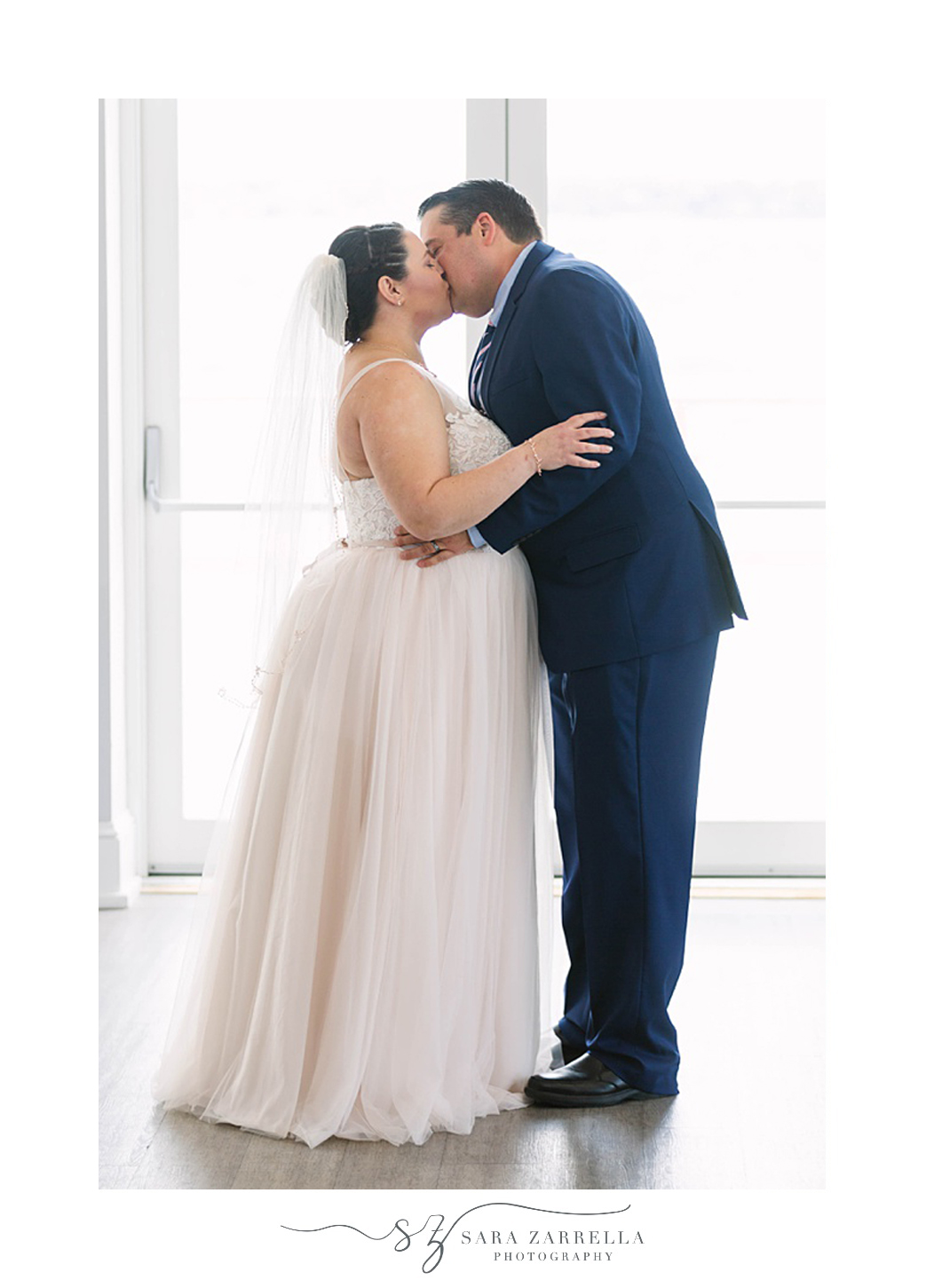 newlyweds kiss during intimate Gurney's Newport Resort wedding ceremony