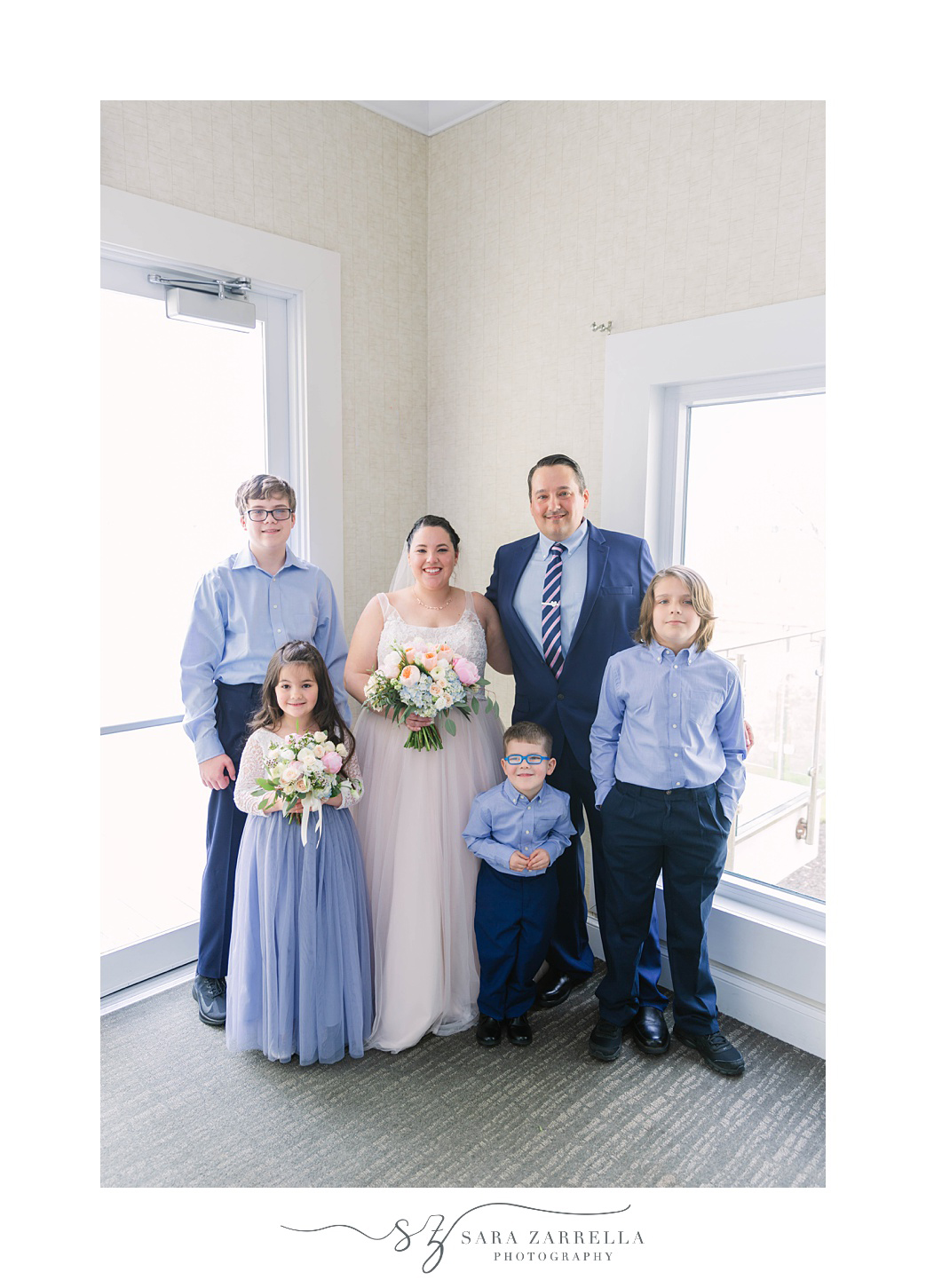 bride and groom pose with four children