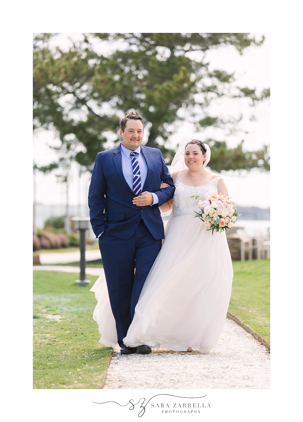 bride and groom walk on pathway at Gurney's Newport Resort