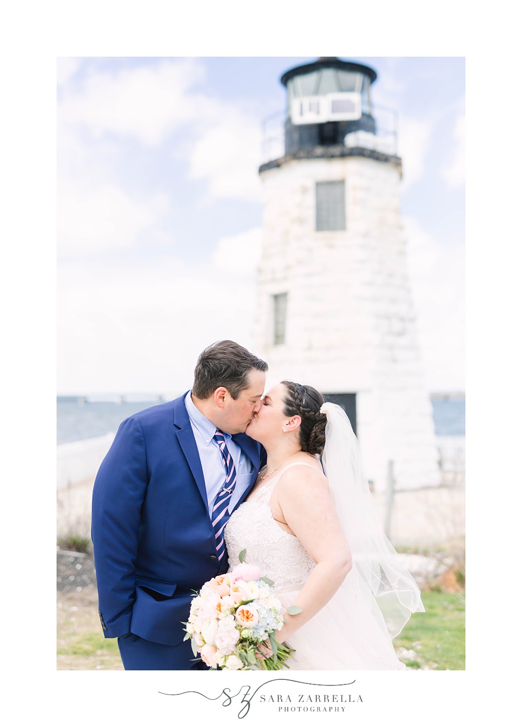 bride and groom kiss by lighthouse outside Gurney's Resort