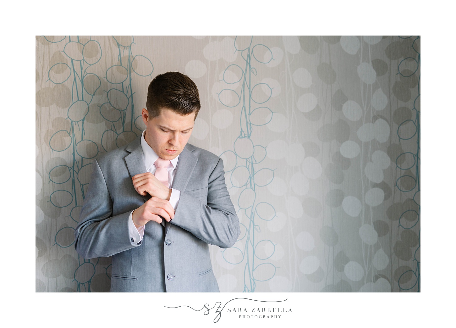 groom adjusts cufflink for RI wedding