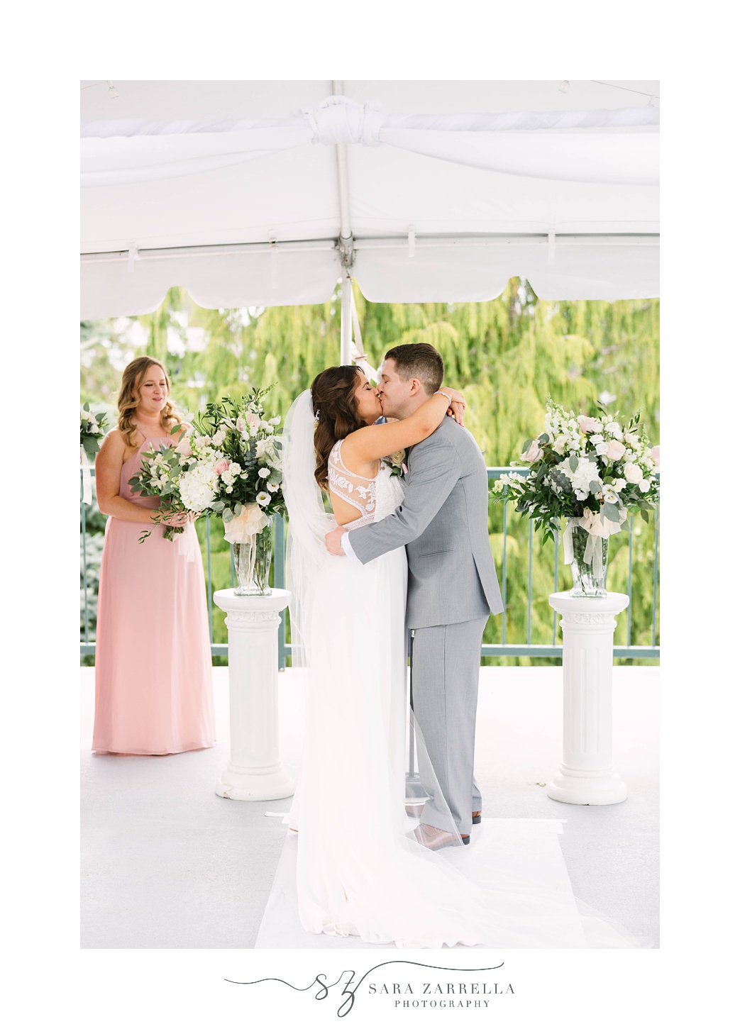 newlyweds kiss during ceremony at Kirkbrae Country Club