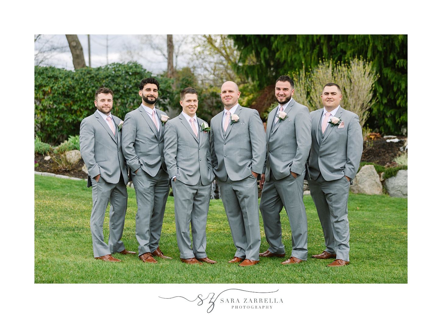 groom and groomsmen in grey suits pose at Kirkbrae Country Club