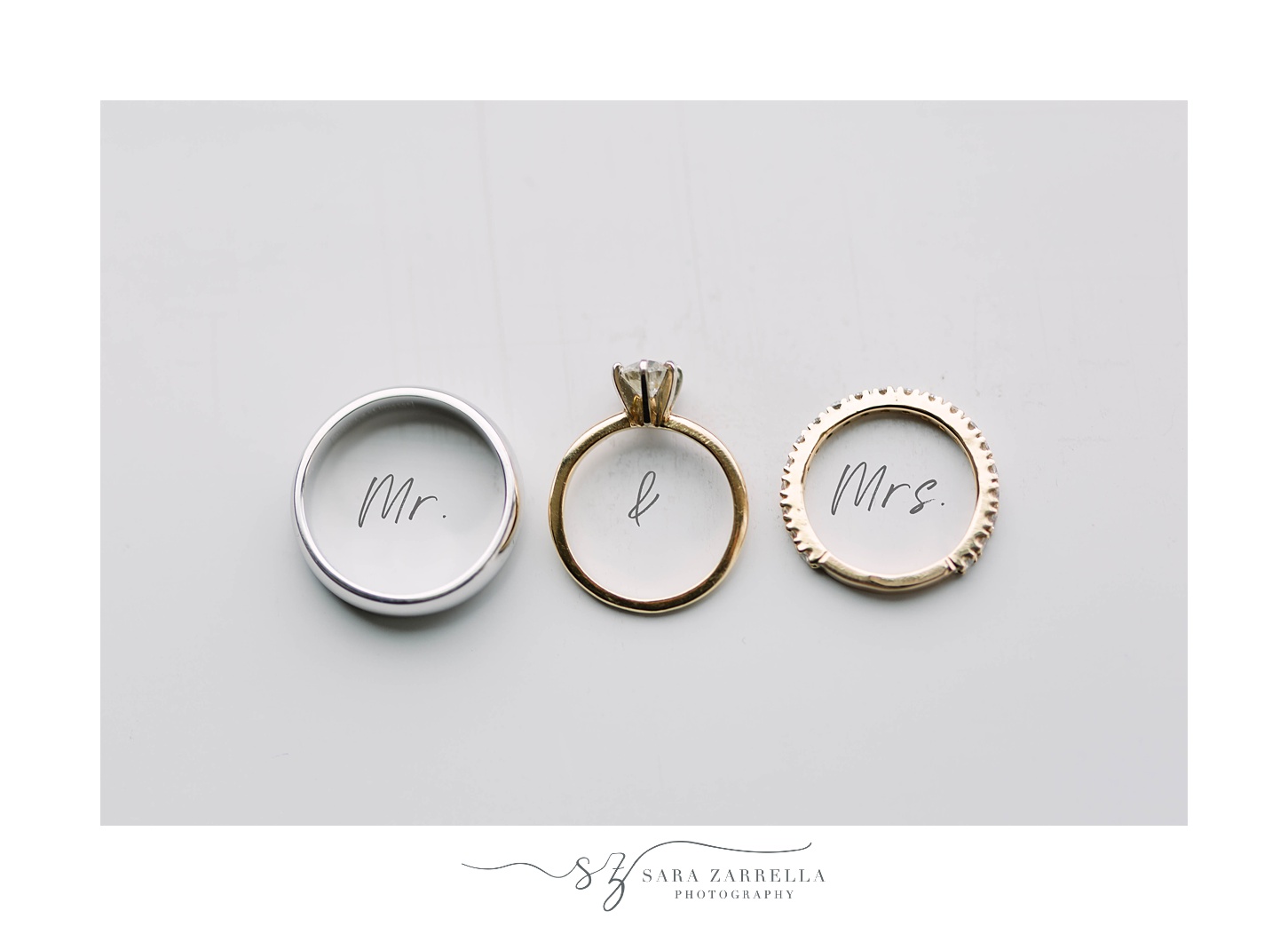 wedding rings rest on mr & mrs in cursive