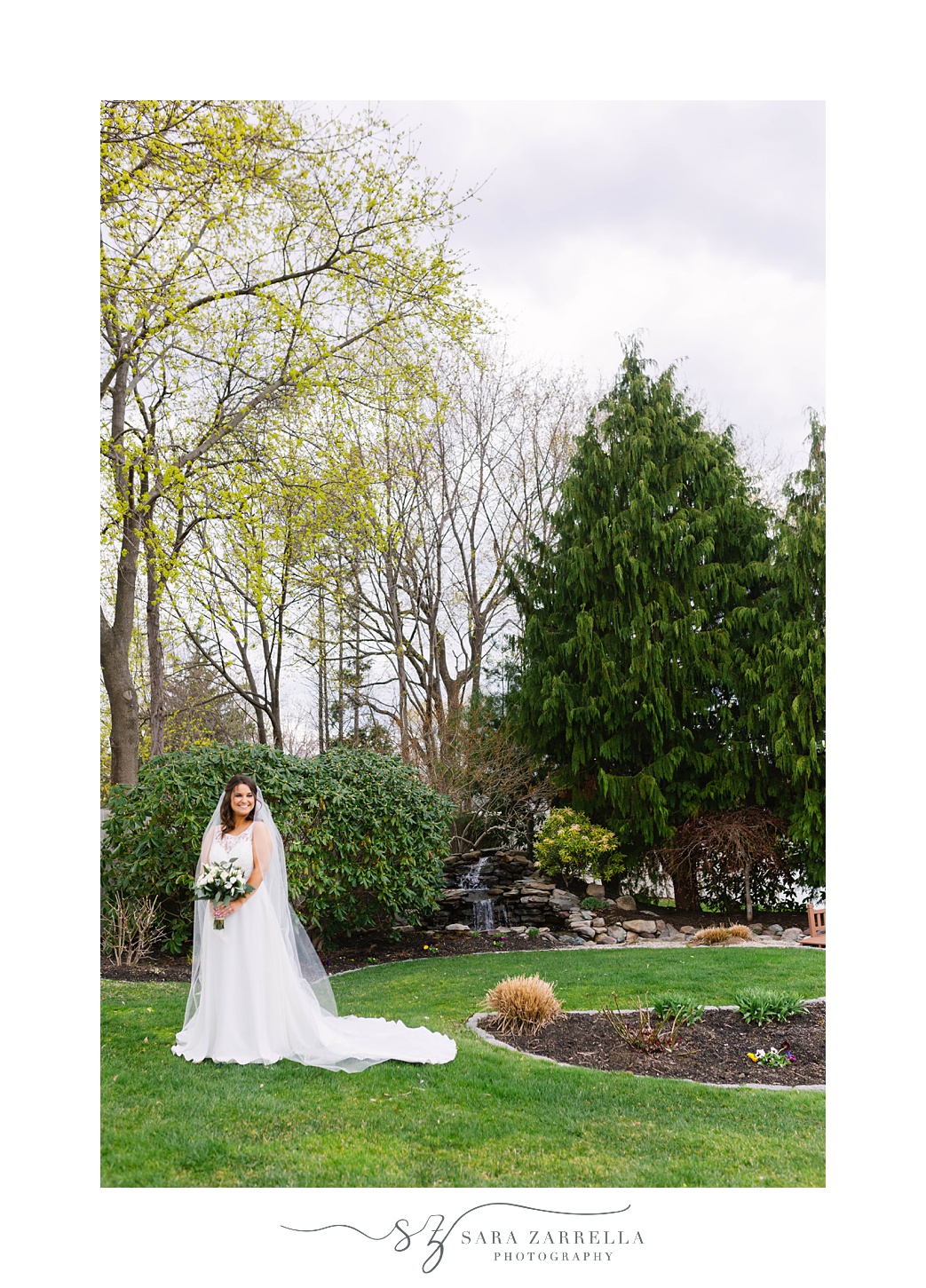 bride poses in gardens at Kirkbrae Country Club