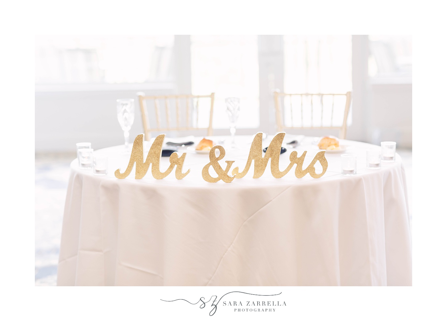 sweetheart table with gold Mr and Mrs signs