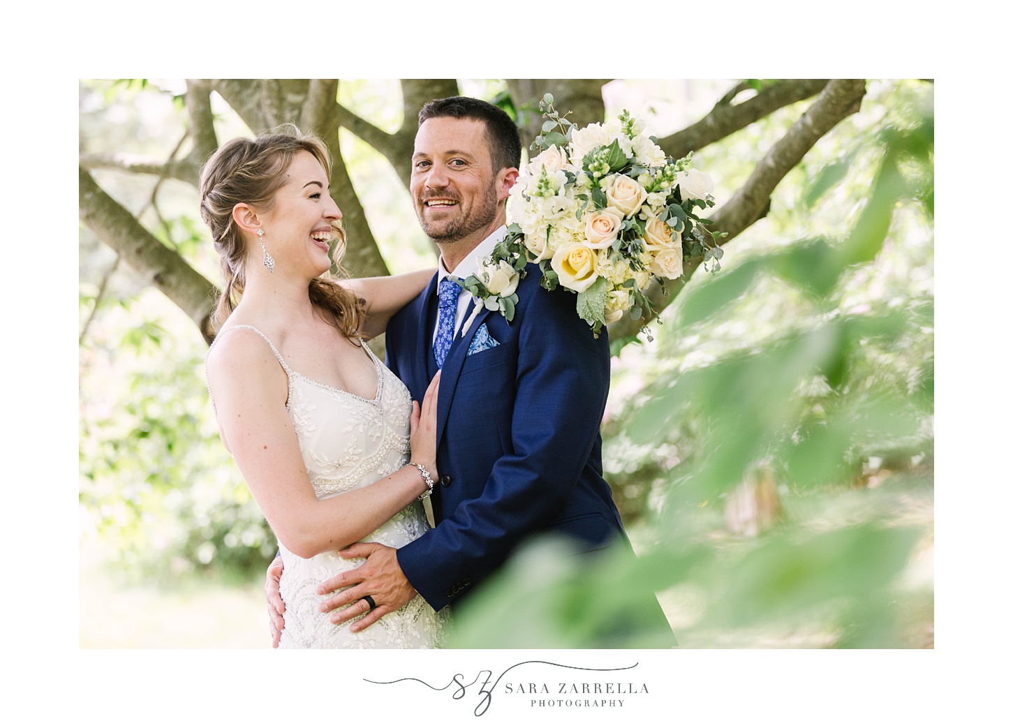 bride and groom laugh together posing in trees in Foster RI