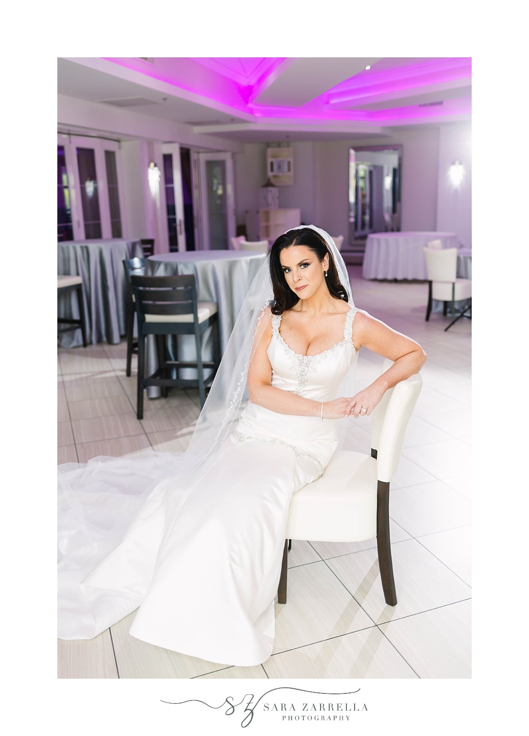bride poses in chair at Skyline at Waterplace