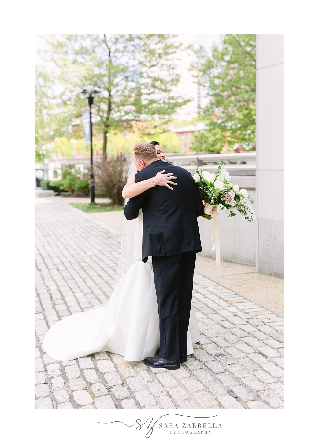 bride and groom hug during first look at Skyline at Waterplace