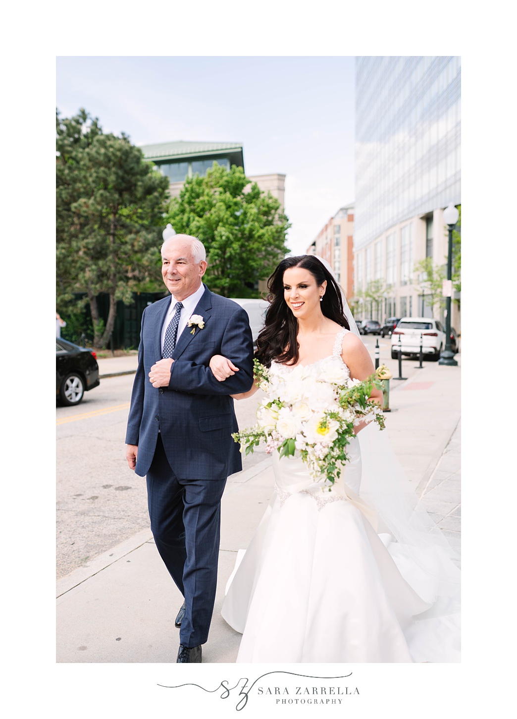 bride walks into wedding ceremony with dad at Skyline at Waterplace