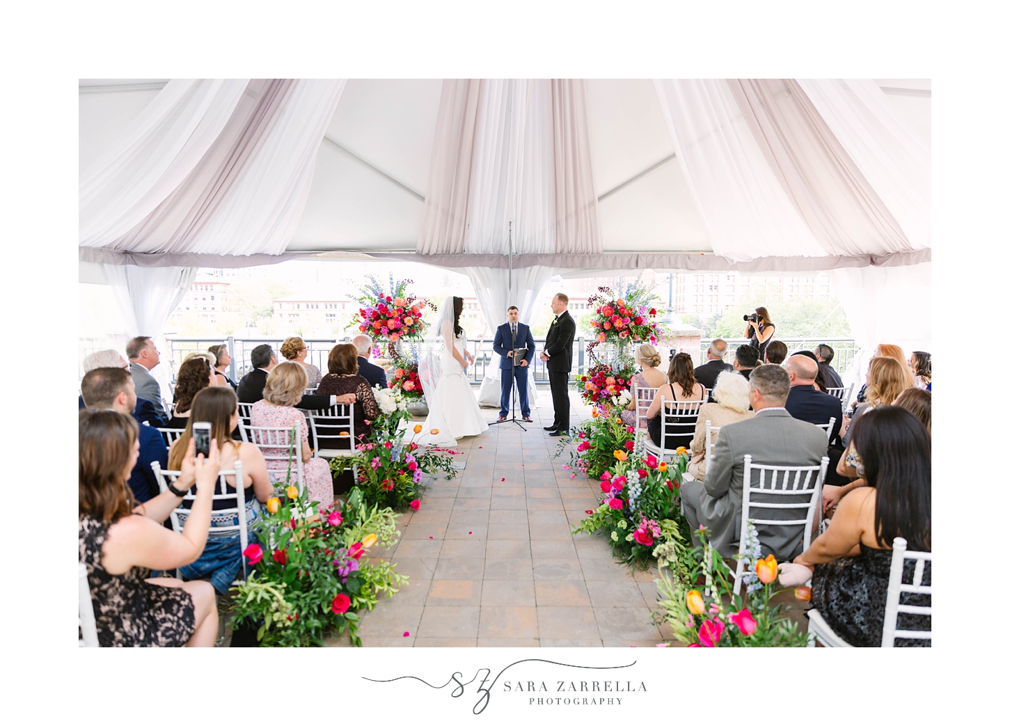 Skyline at Waterplace wedding ceremony with florals down aisle
