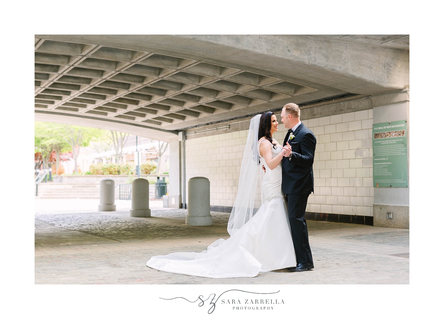 bride and groom pose under bridge in Providence RI