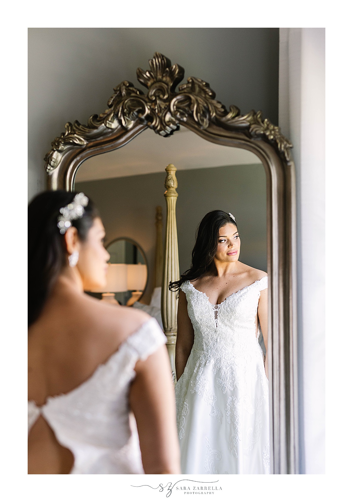 bride looks at herself in mirror
