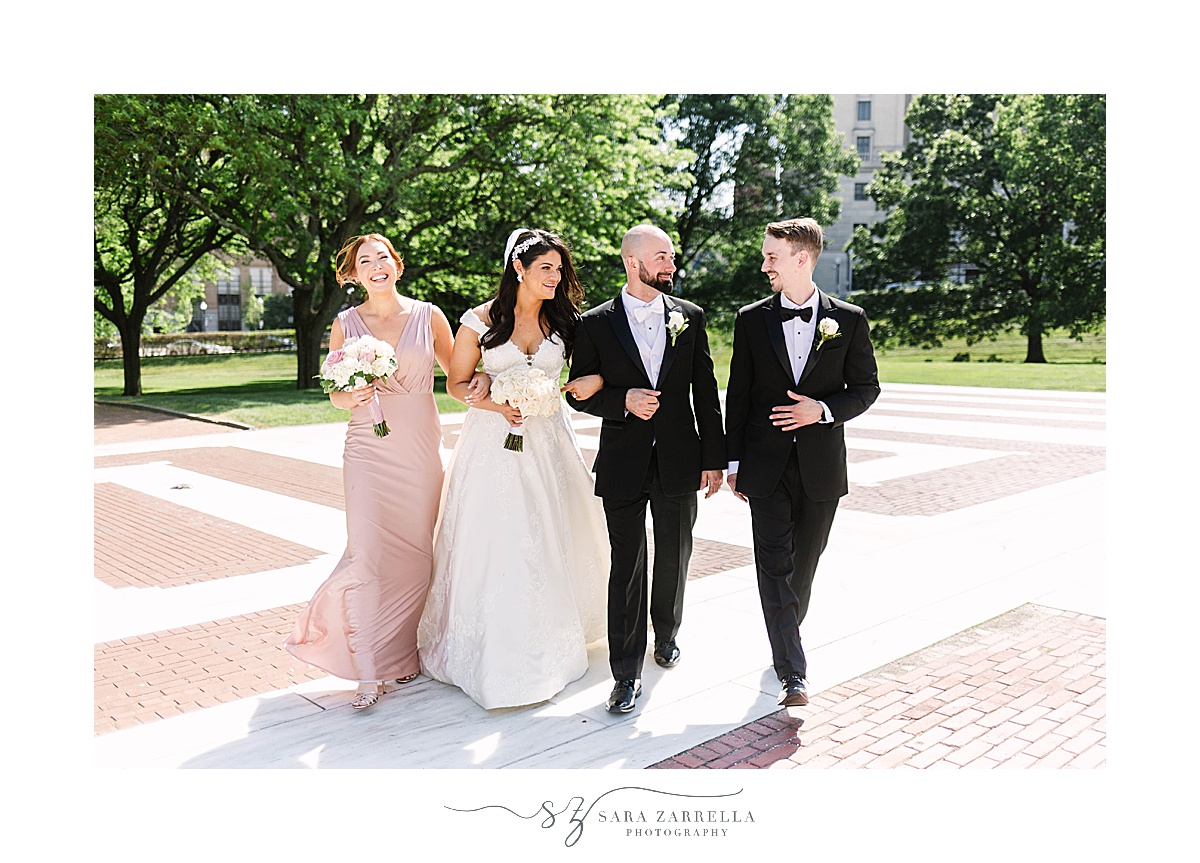 bride and groom walk with wedding party in Rhode Island