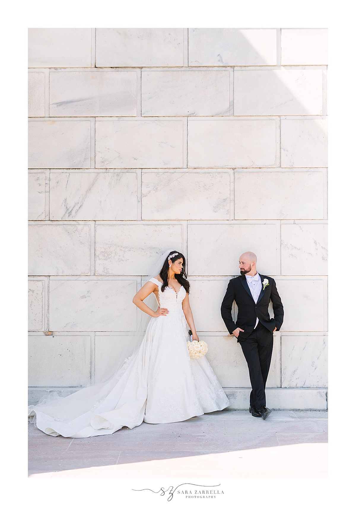 newlyweds pose against stone wall of State House in RI
