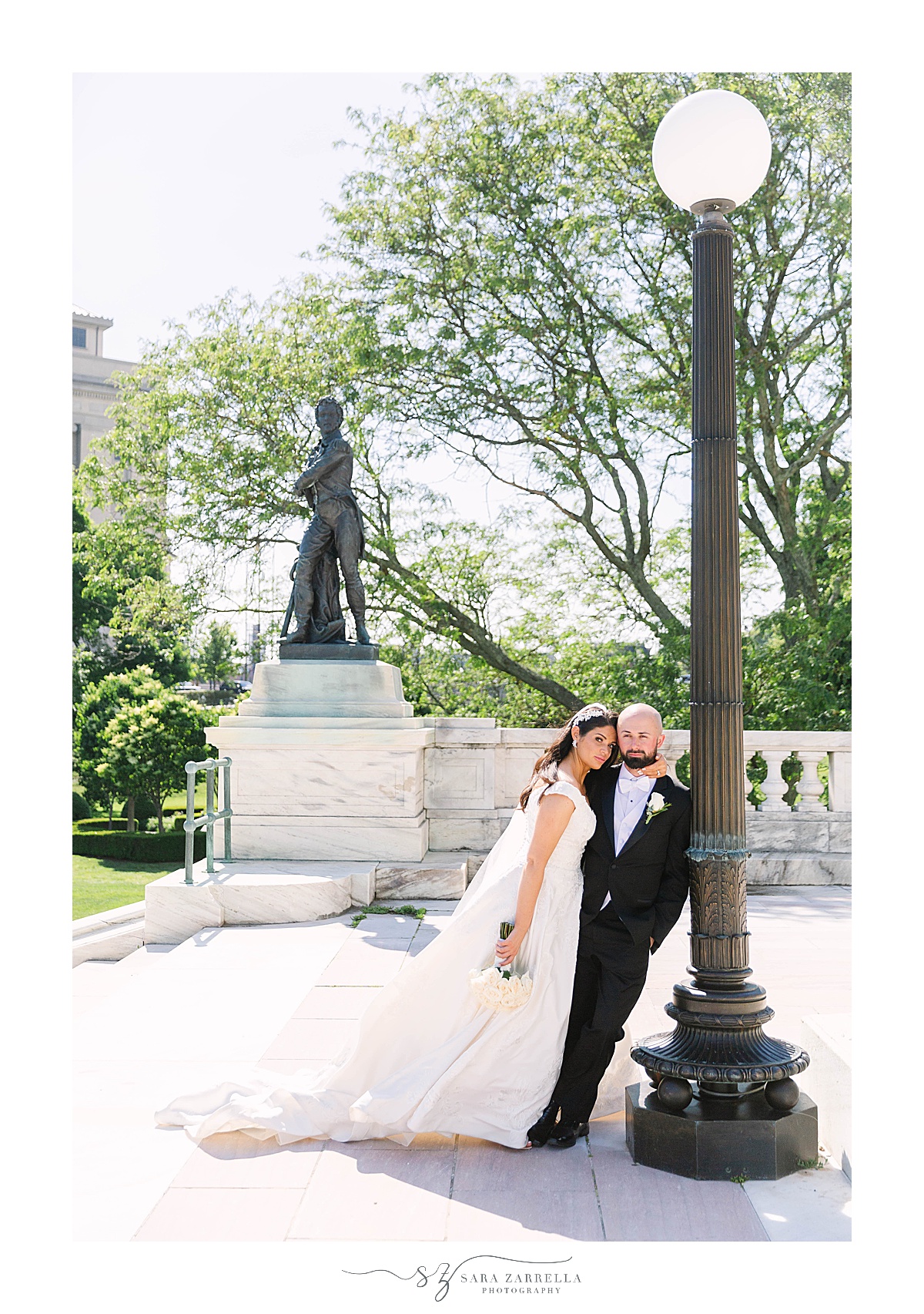 newlyweds lean against lamp post at State House
