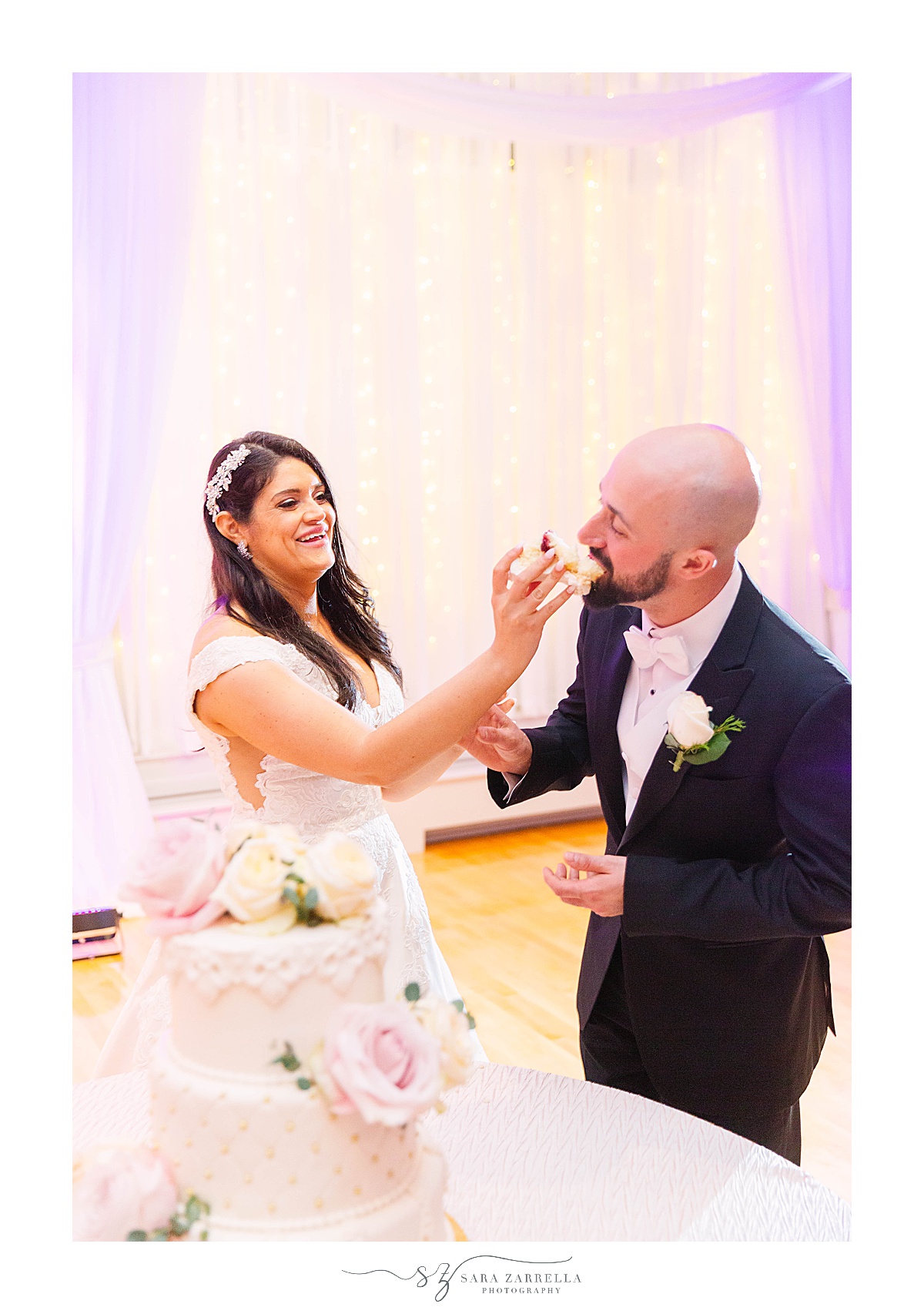 bride feeds groom cake during wedding reception in RI