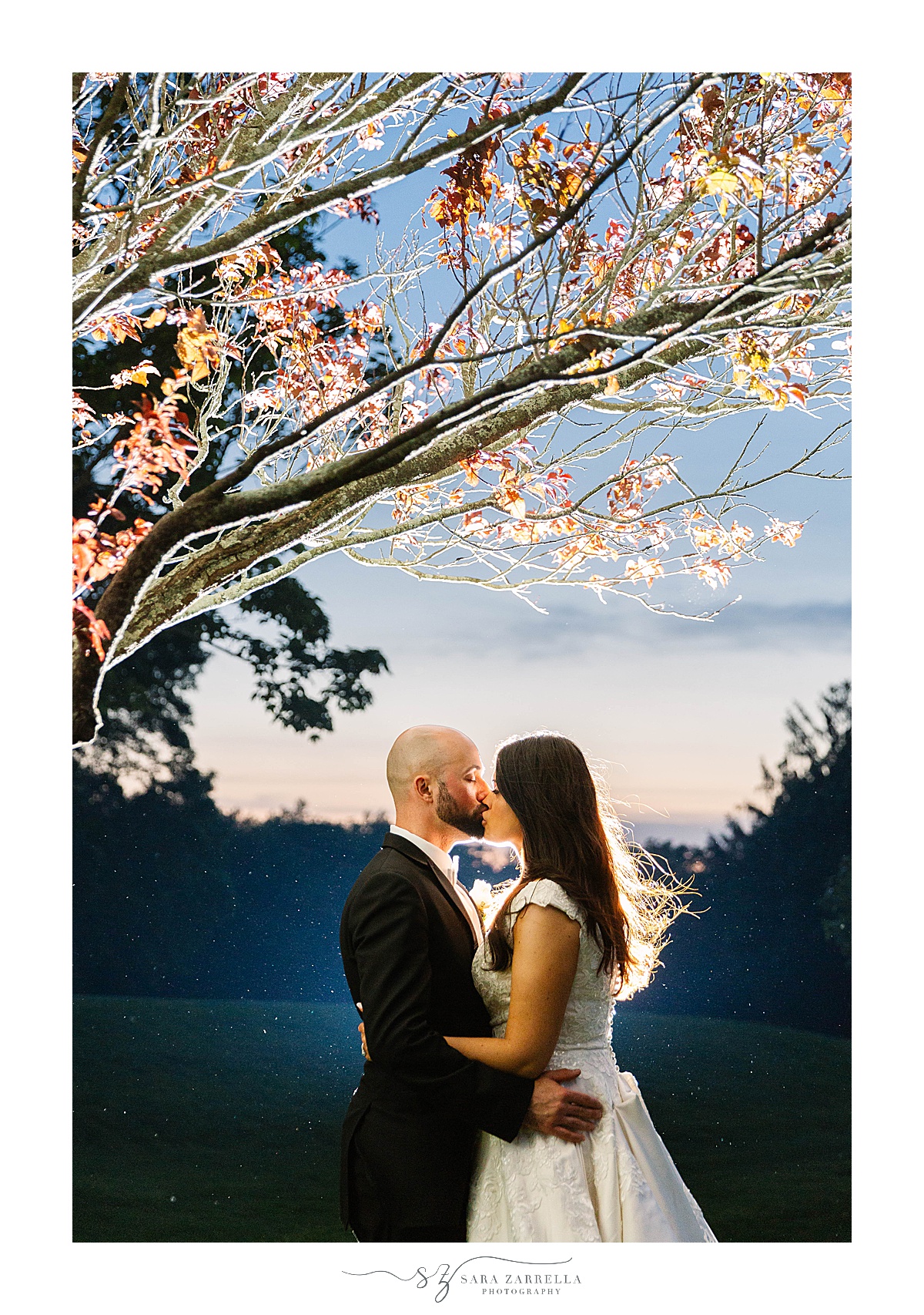 newlyweds kiss under pink tree at  Alpine Country Club