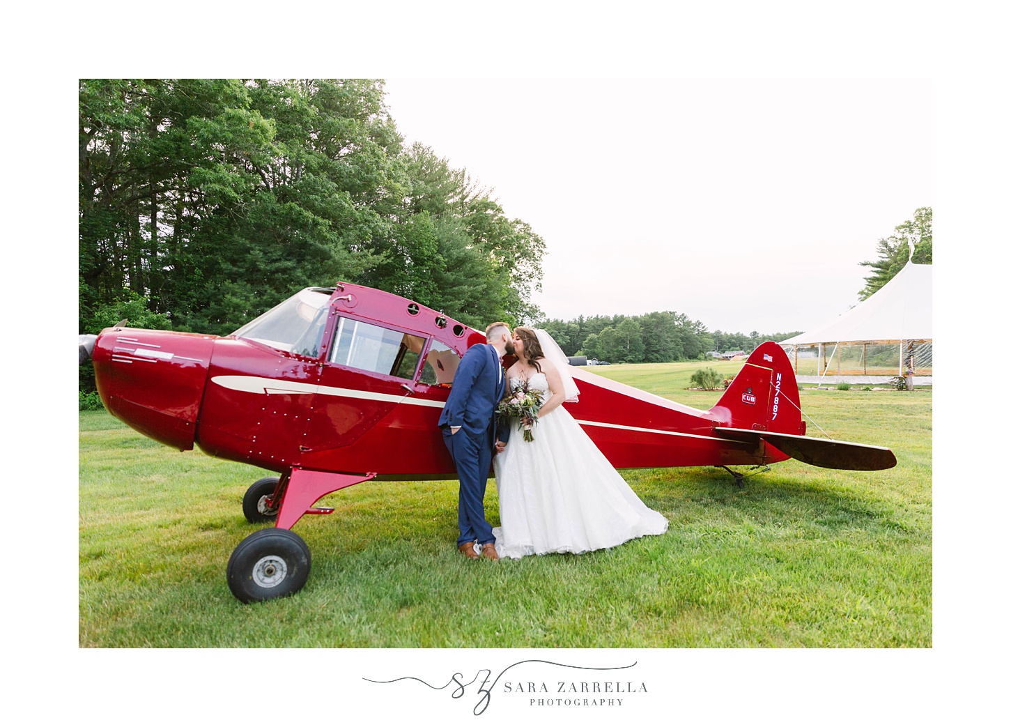 wedding portraits by red airplane at Arch at the Meadow