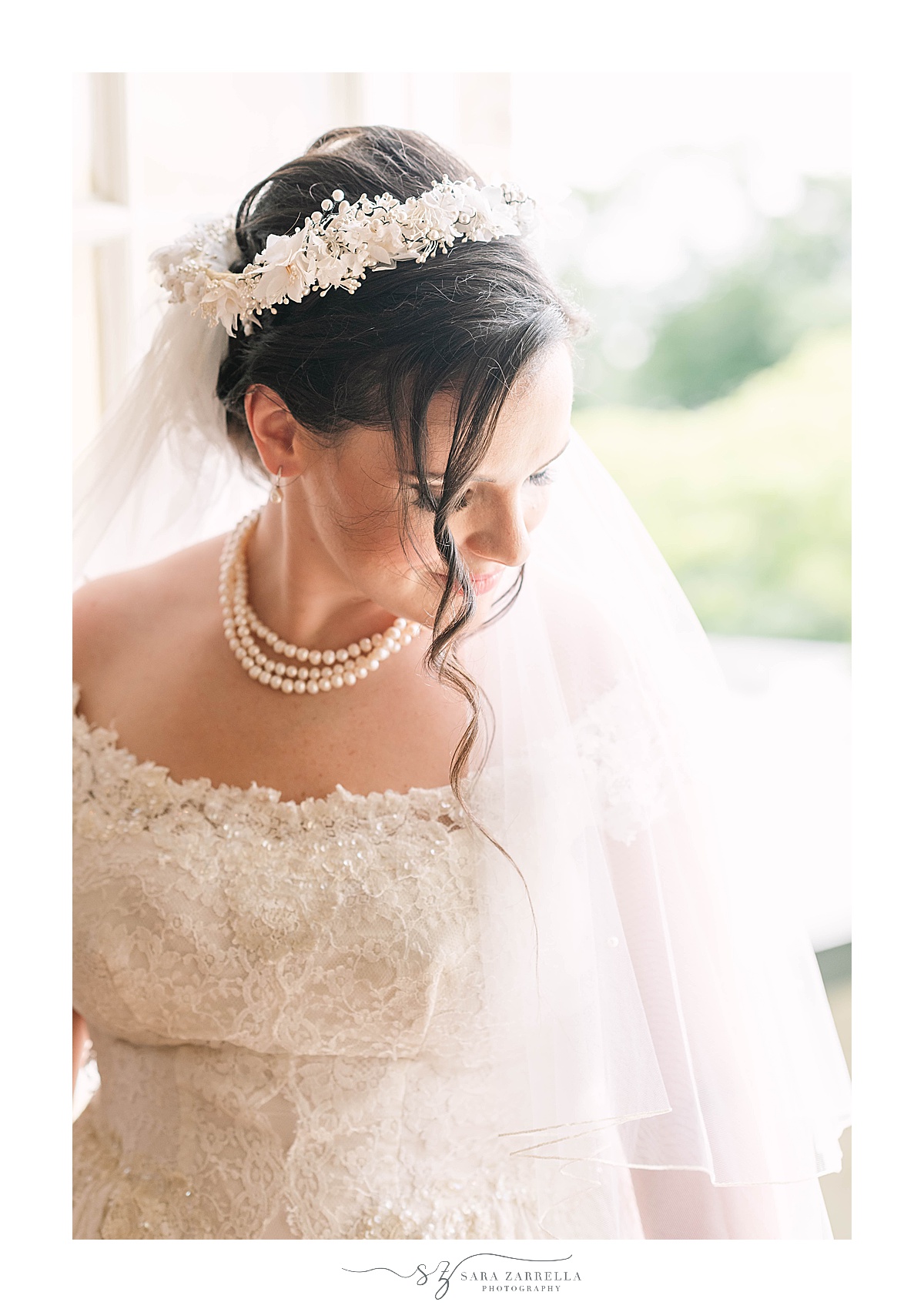 bride looks over shoulder with flower crown veil wearing grandmother's wedding gown