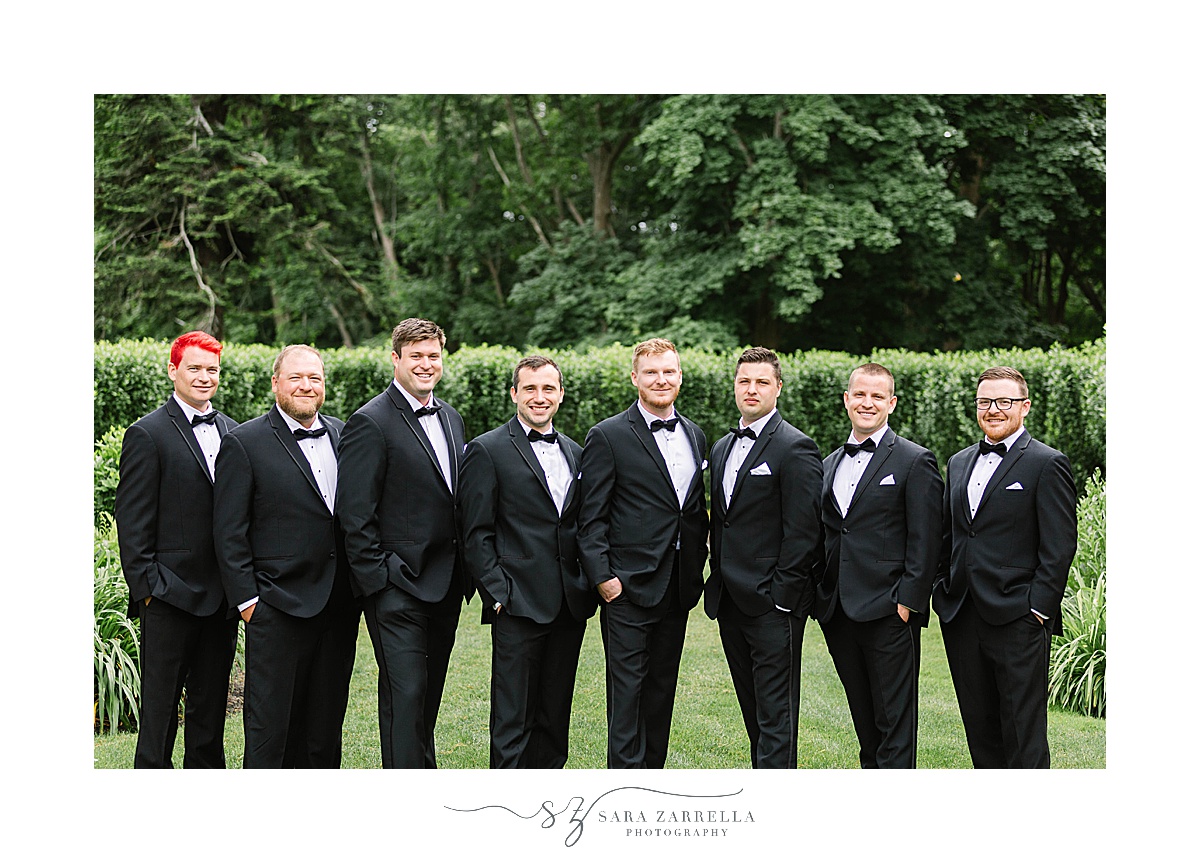groom stand with groomsmen in classic suits