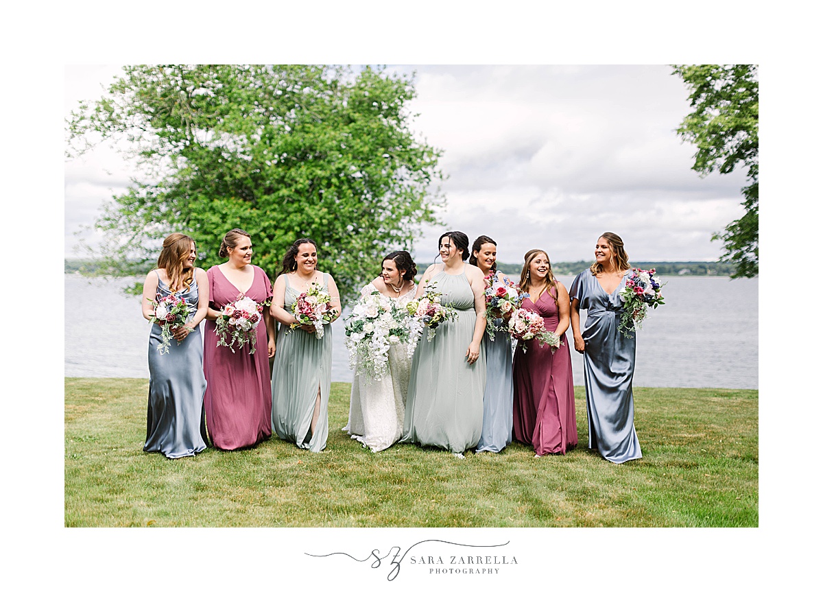 bride and bridesmaids in metallic tones walk along water