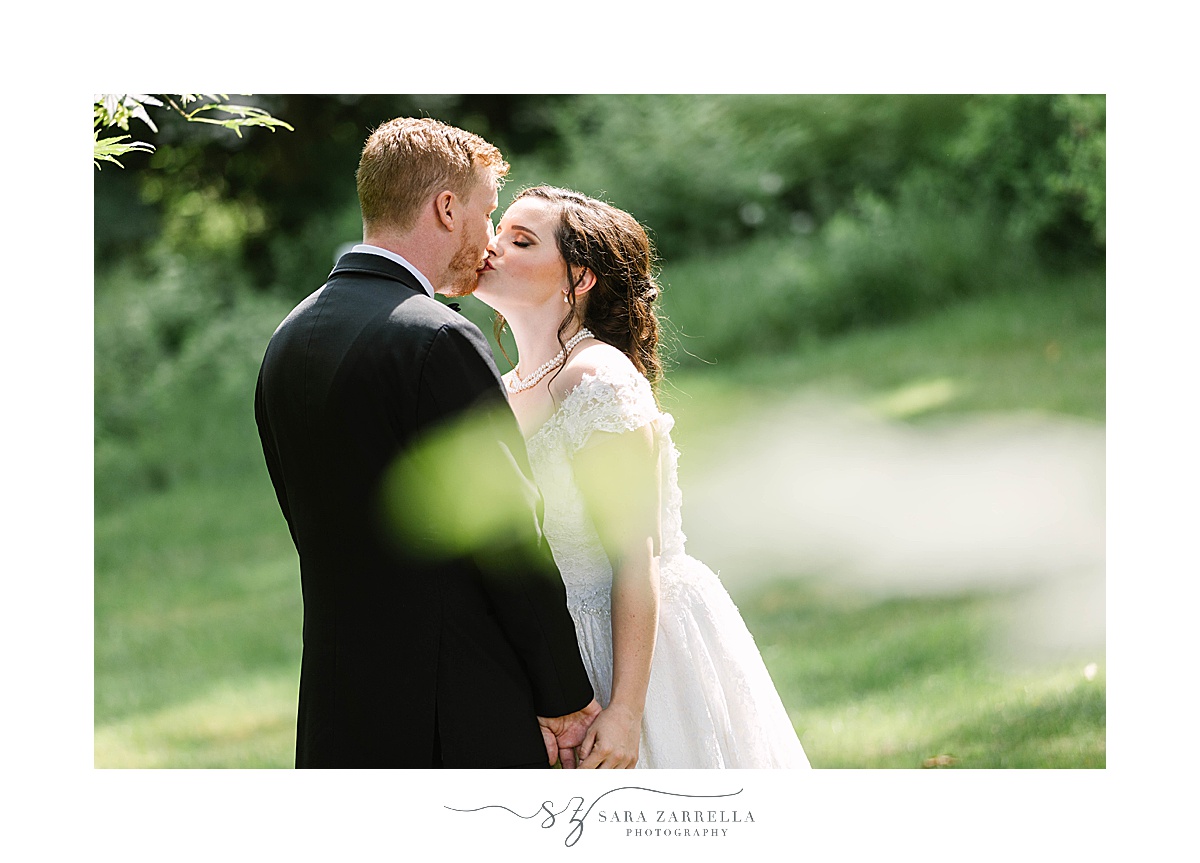 newlyweds kiss in front yard at Glen Manor House