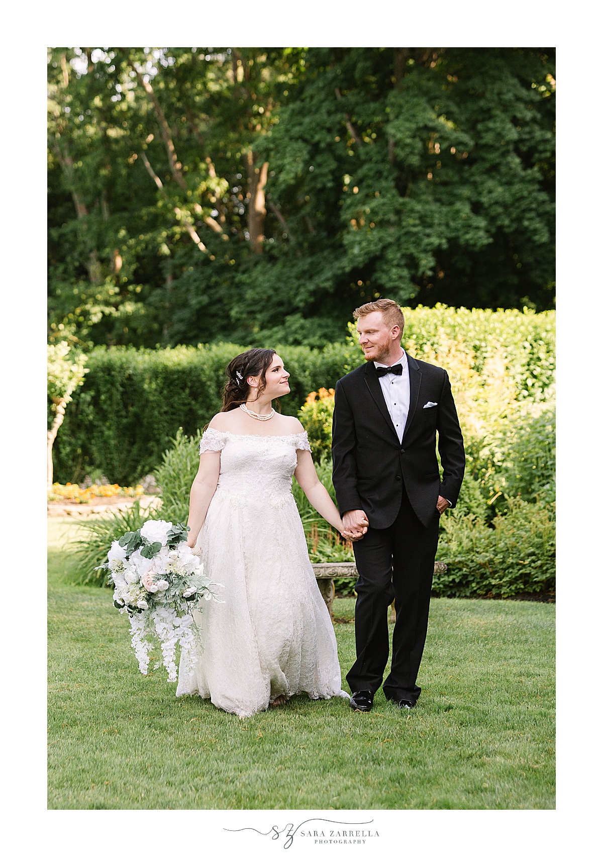 bride and groom hold hands walking through gardens at Glen Manor House