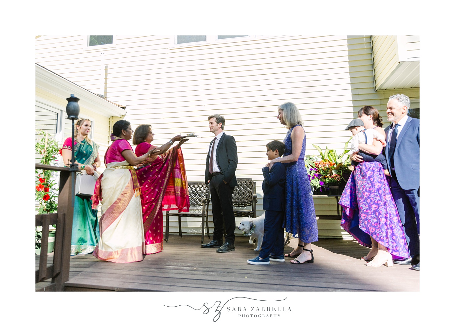 family enters home for traditional Hindu wedding ceremony 